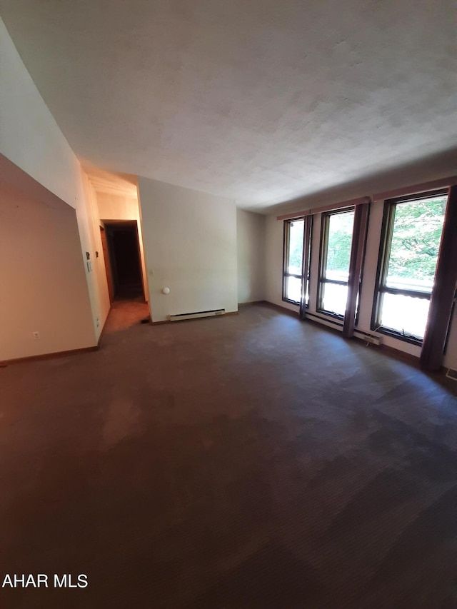 carpeted empty room featuring a baseboard radiator