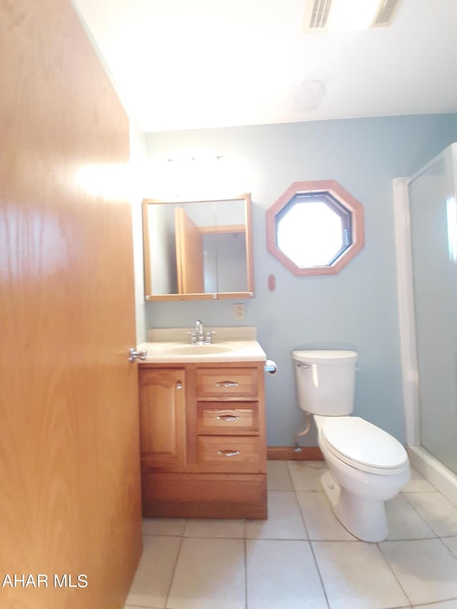 bathroom featuring tile patterned floors, vanity, and toilet