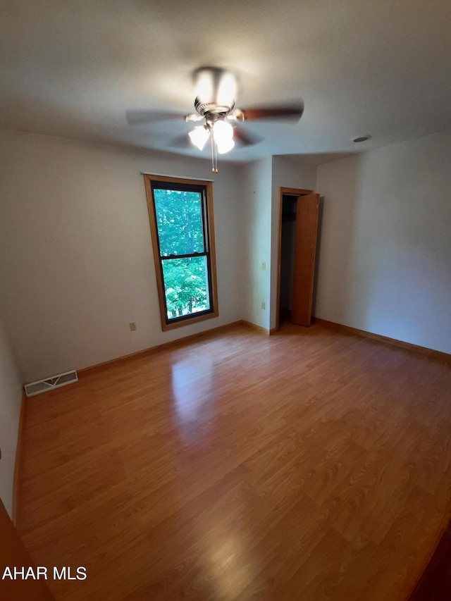 spare room featuring ceiling fan and wood-type flooring