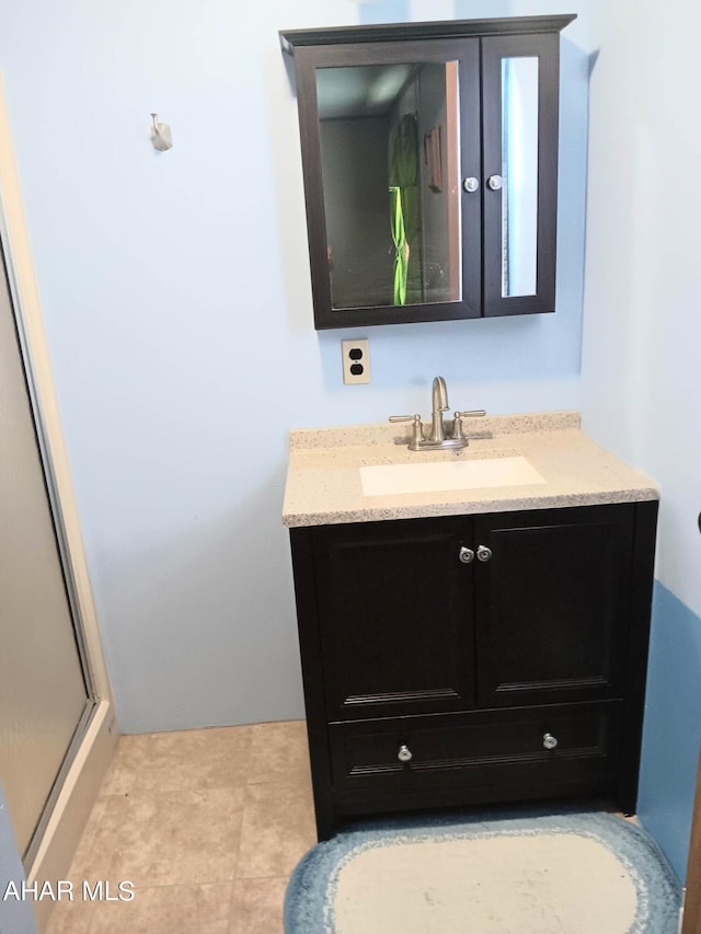 bathroom with vanity and a shower with shower door