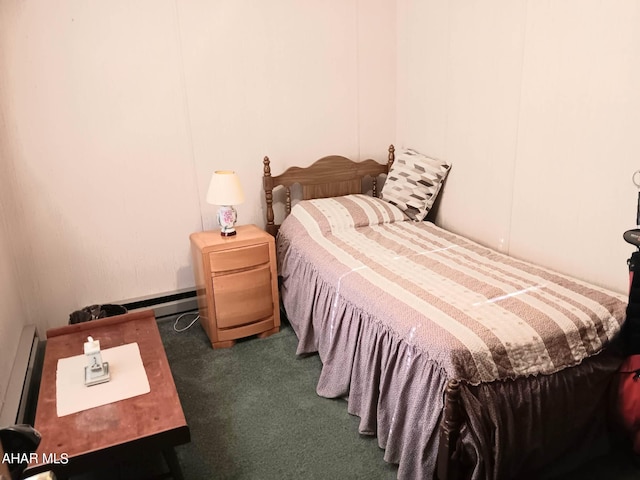 bedroom with a baseboard heating unit and dark colored carpet