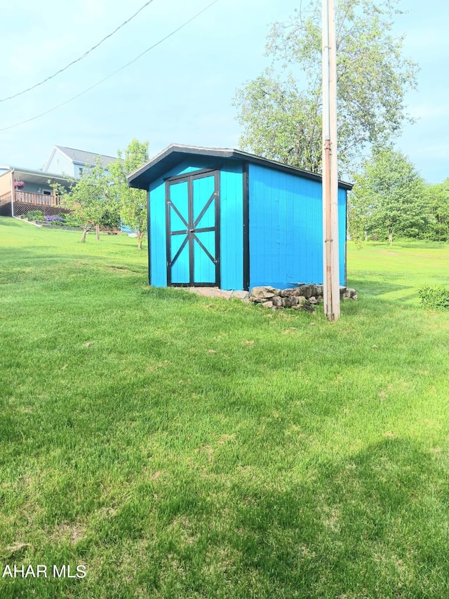 view of outbuilding featuring a lawn