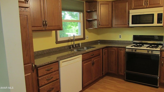703 Ruskin Dr, Altoona, PA 16602 - kitchen with white appliances, dark stone counters, light wood-style flooring, open shelves, and brown cabinetry
