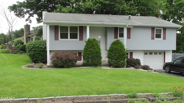 703 Ruskin Dr, Altoona, PA 16602 - bi-level home featuring a garage, a front lawn, asphalt driveway, and a chimney