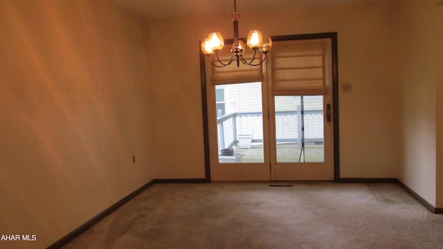 703 Ruskin Dr, Altoona, PA 16602 - empty room with a chandelier and carpet flooring