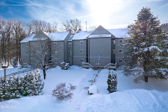 view of snow covered back of property