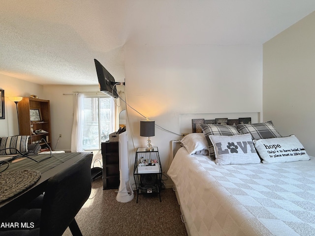 carpeted bedroom with a textured ceiling