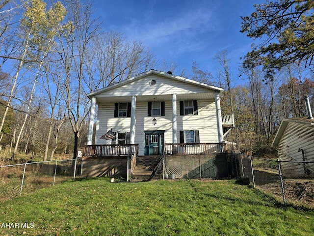 back of property featuring a yard and a deck