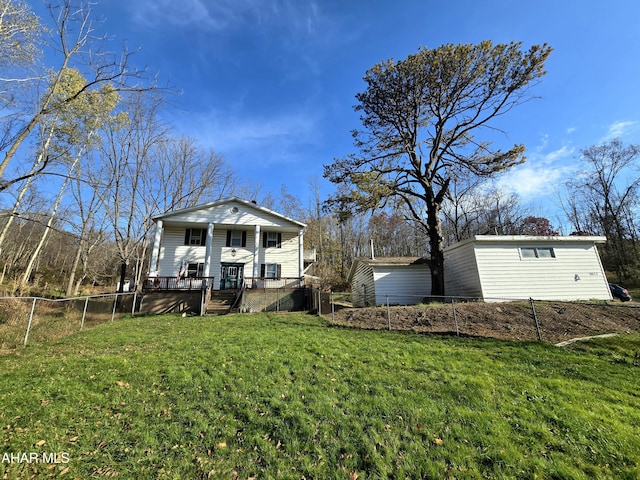 rear view of property featuring a lawn and a porch