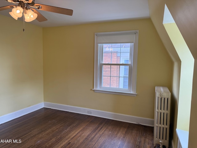 bonus room featuring a ceiling fan, radiator, baseboards, and wood finished floors