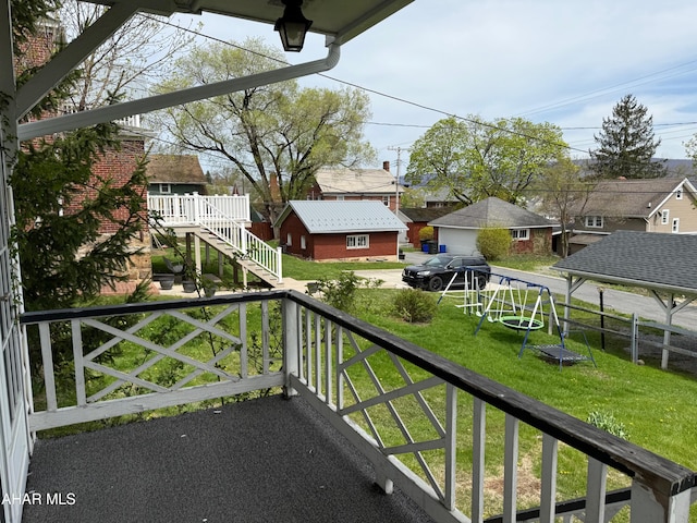 balcony featuring stairway and a residential view