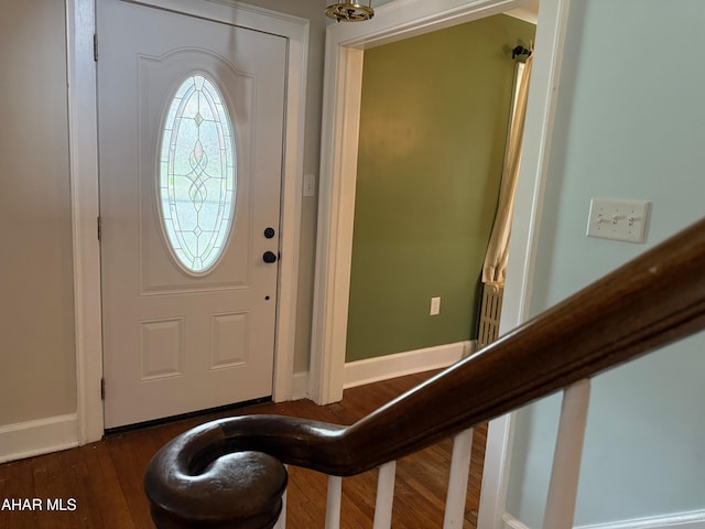 foyer with baseboards and dark wood finished floors