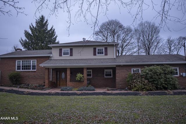 tri-level home with a front lawn