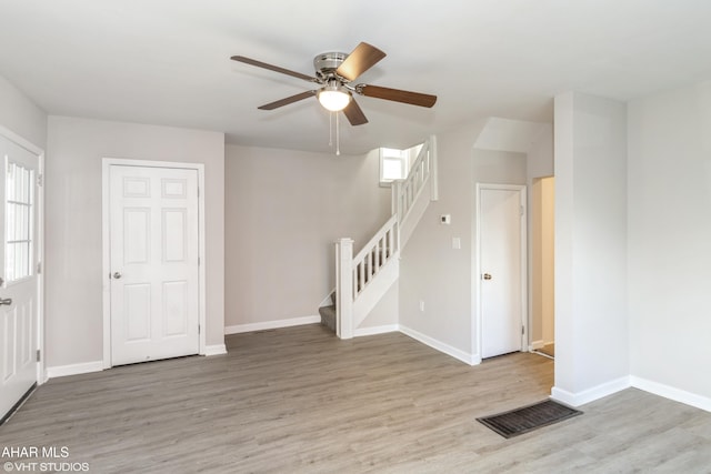 320 2nd Ave, Altoona, PA 16602 - interior space featuring stairway, baseboards, wood finished floors, and a ceiling fan