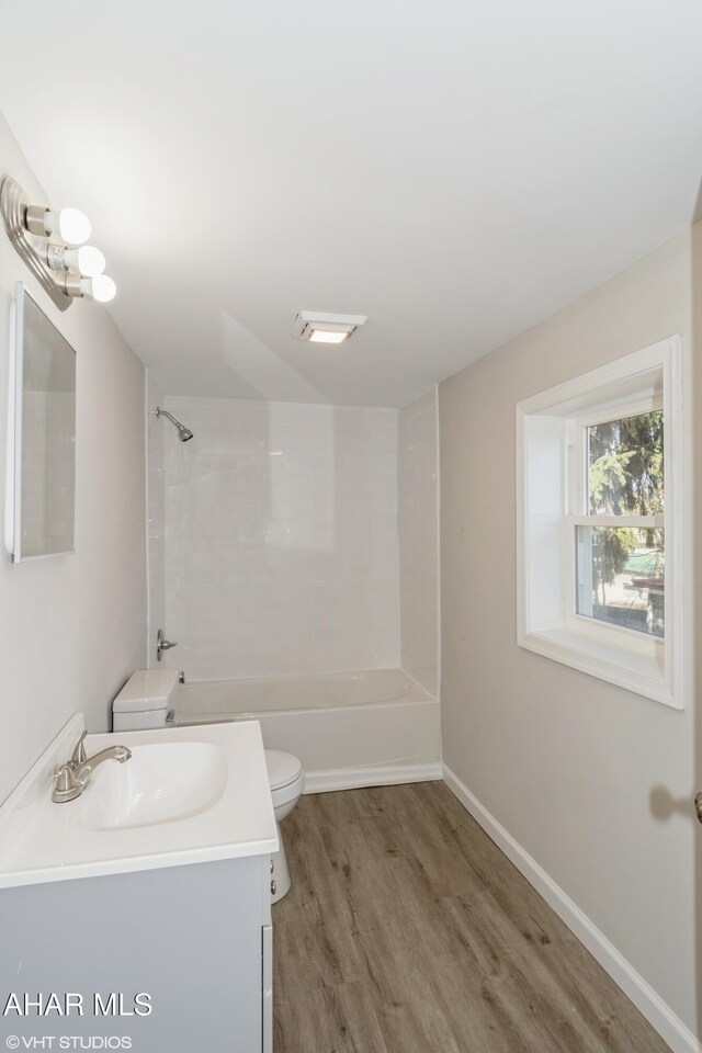 320 2nd Ave, Altoona, PA 16602 - full bath featuring vanity, wood finished floors, baseboards, shower / bathing tub combination, and toilet