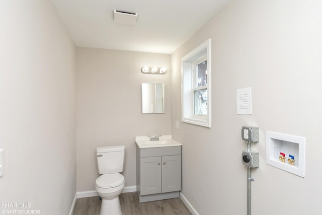 320 2nd Ave, Altoona, PA 16602 - half bathroom featuring vanity, toilet, wood finished floors, and baseboards
