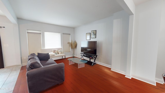 living area featuring wood-type flooring and baseboards