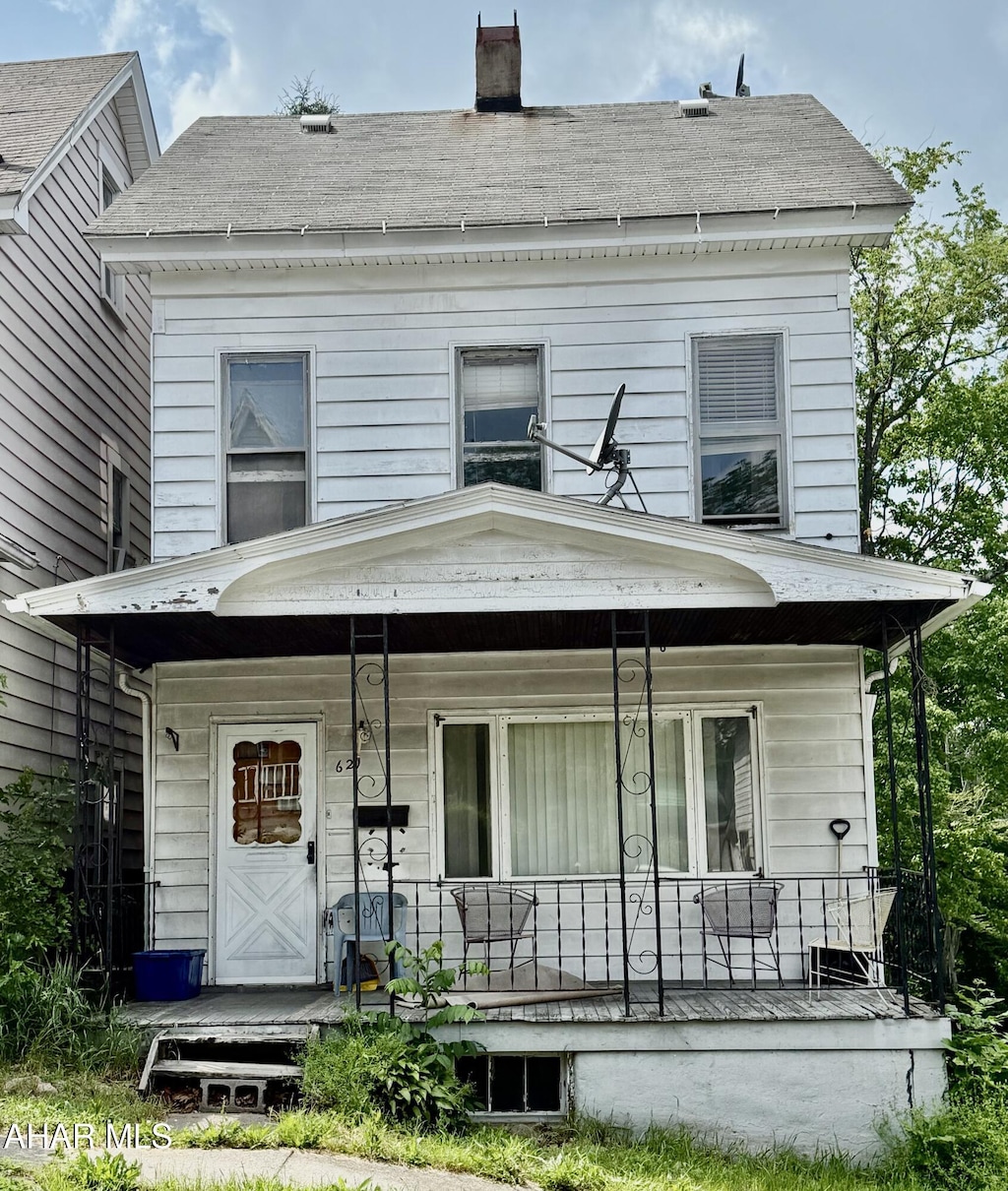 621 N 10th Ave, Altoona, PA 16601 - back of house with a porch, a chimney, and roof with shingles