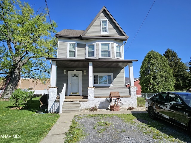 view of front of home featuring covered porch and a front yard