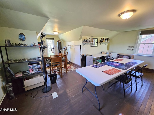 dining space featuring baseboards, dark wood-style flooring, and vaulted ceiling