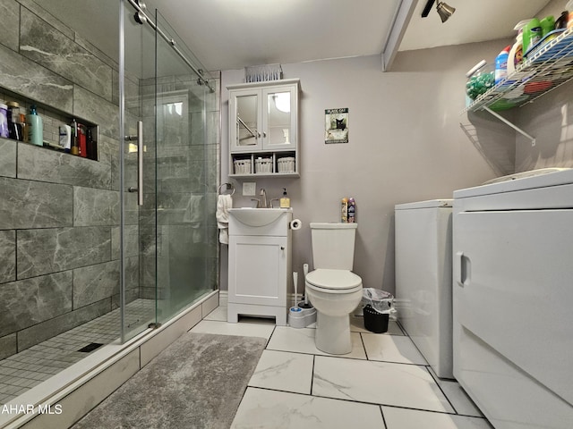 bathroom with vanity, marble finish floor, a stall shower, and toilet
