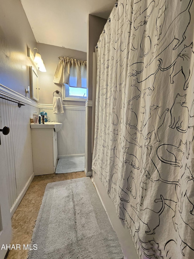 bathroom featuring vanity and wainscoting