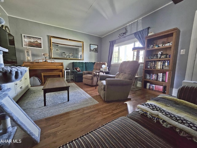 living room with crown molding and wood finished floors