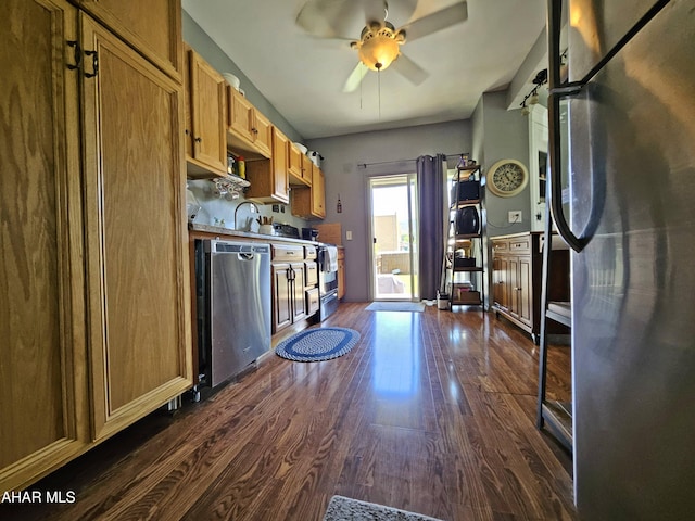 kitchen with brown cabinetry, dark wood-style floors, light countertops, a ceiling fan, and stainless steel appliances
