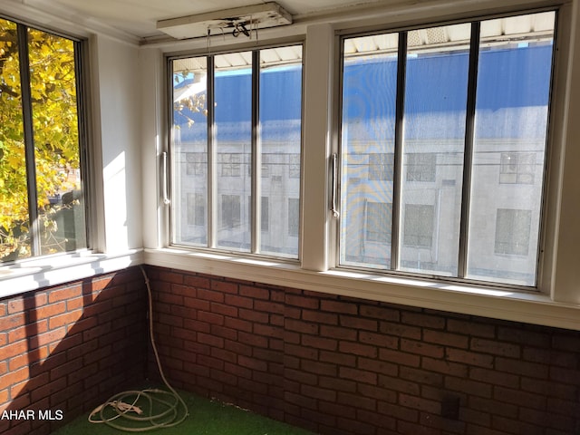 unfurnished sunroom featuring a healthy amount of sunlight