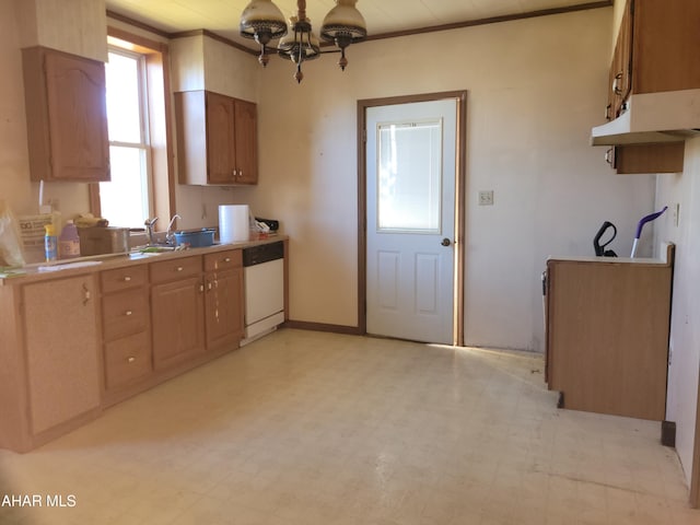 kitchen featuring white dishwasher, sink, and a chandelier