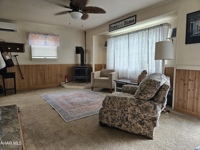 2802 Elm St, Altoona, PA 16601 - living room with an AC wall unit, a wood stove, wooden walls, a wainscoted wall, and a ceiling fan