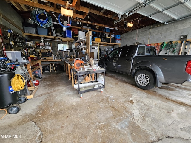 2802 Elm St, Altoona, PA 16601 - garage with a garage door opener, concrete block wall, and a workshop area