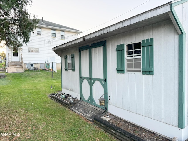 view of outdoor structure featuring a lawn