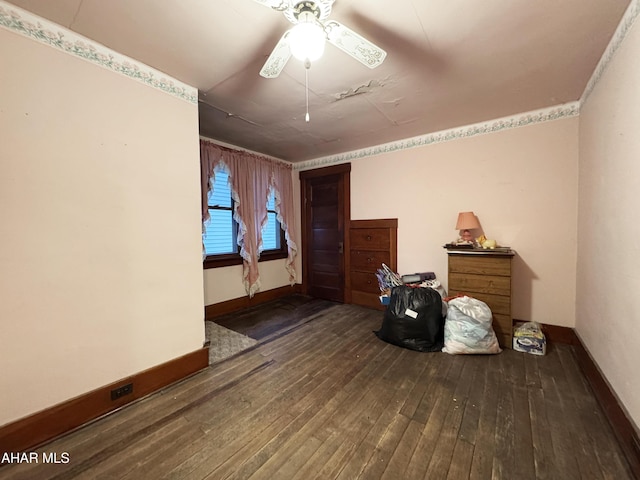 interior space with hardwood / wood-style flooring, ceiling fan, and baseboards