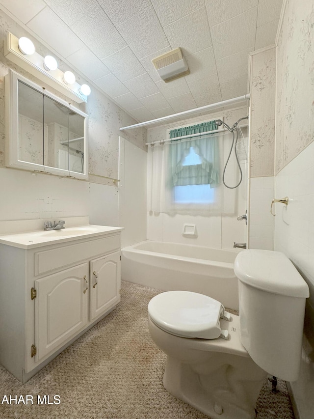 full bath featuring wallpapered walls, wainscoting, toilet,  shower combination, and vanity