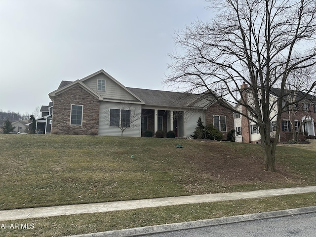 view of front of property with stone siding and a front lawn