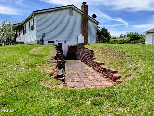 151 Rio Grande Rd, Clearville, PA 15535 - view of side of property featuring a chimney, a yard, and stairway