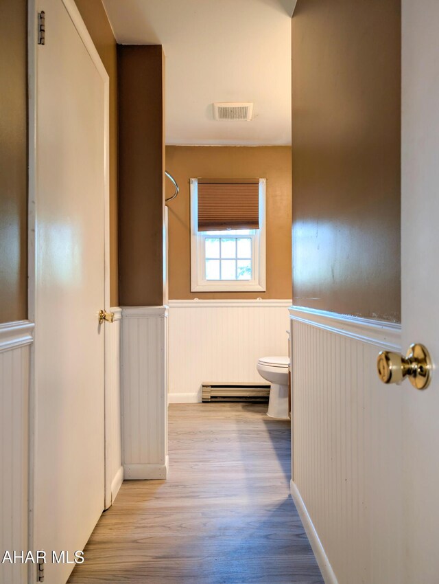 151 Rio Grande Rd, Clearville, PA 15535 - bathroom with a baseboard heating unit, toilet, wainscoting, wood finished floors, and a shower