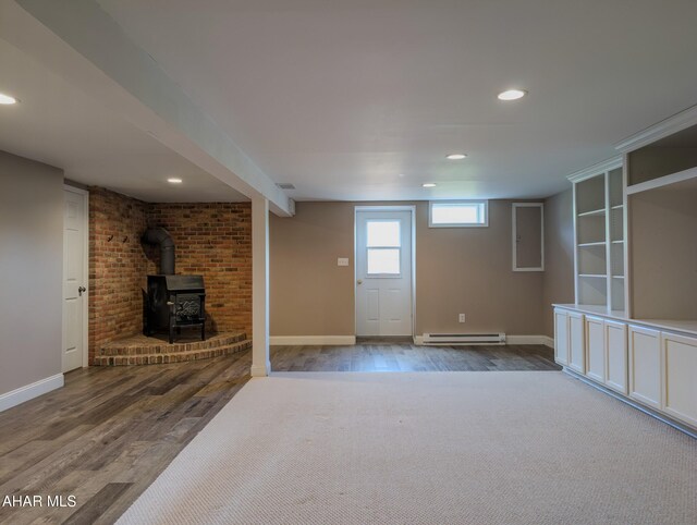 151 Rio Grande Rd, Clearville, PA 15535 - unfurnished living room featuring a baseboard radiator, wood finished floors, a wood stove, recessed lighting, and baseboards