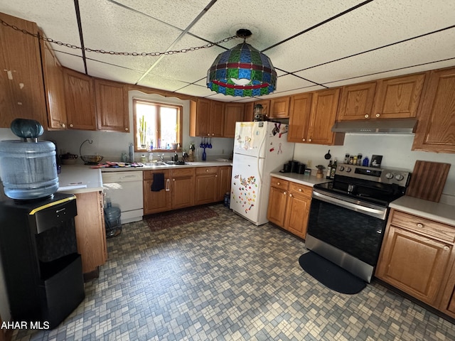 kitchen featuring a paneled ceiling, sink, decorative light fixtures, and white appliances