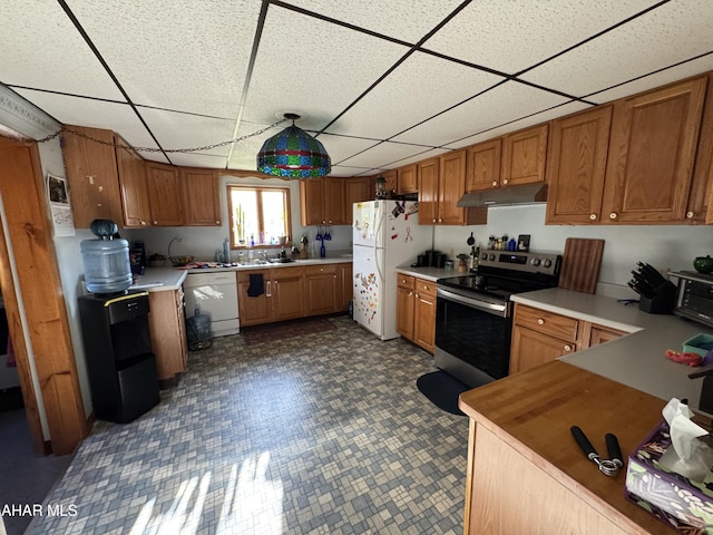 kitchen featuring a paneled ceiling and white appliances