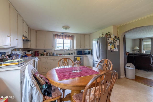 7241 Morgans Rd, Huntingdon, PA 16652 - kitchen with appliances with stainless steel finishes, under cabinet range hood, arched walkways, light countertops, and a sink