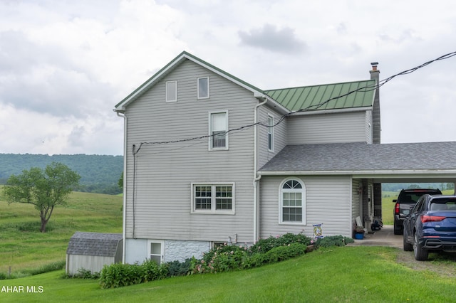 7241 Morgans Rd, Huntingdon, PA 16652 - view of home's exterior with a yard, a standing seam roof, a chimney, metal roof, and a carport