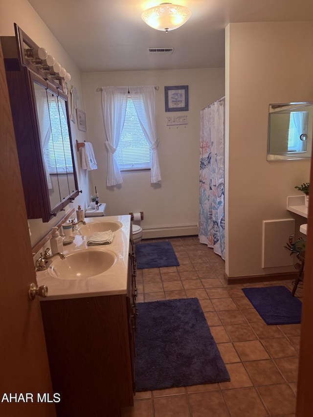 524 Elm Ln, Duncansville, PA 16635 - bathroom featuring healthy amount of natural light, double vanity, tile patterned floors, and a baseboard radiator
