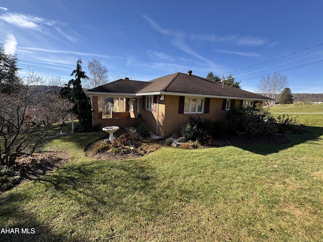 view of side of home featuring a lawn