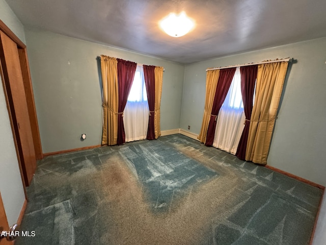 empty room with dark carpet