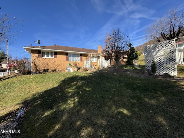 rear view of property featuring a yard