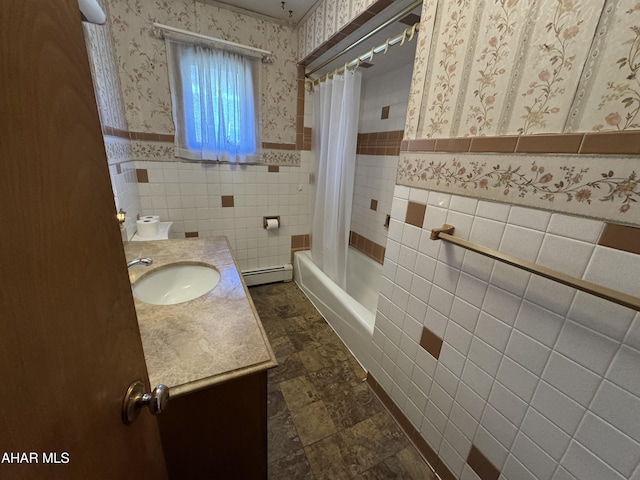 bathroom featuring vanity, shower / bathtub combination with curtain, baseboard heating, and tile walls