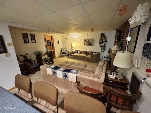 living room with carpet and a drop ceiling