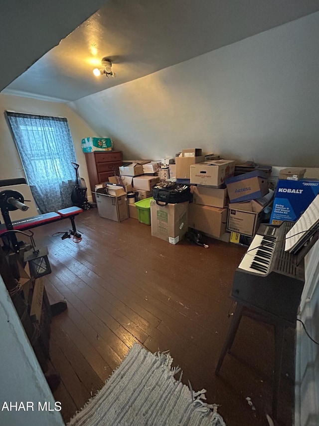 additional living space with dark wood-type flooring and lofted ceiling